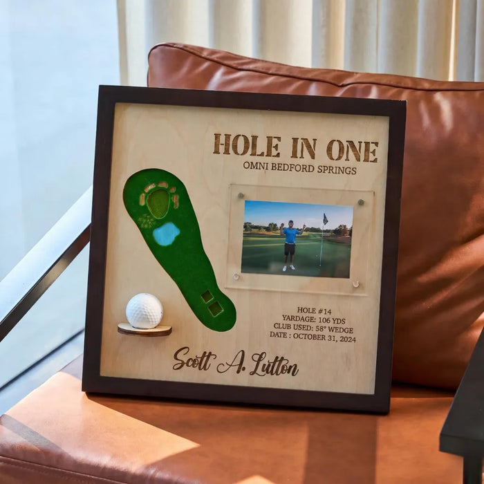 Framed golf-themed picture with a golf ball, green hole diagram, and photo of a golfer on a golf course.